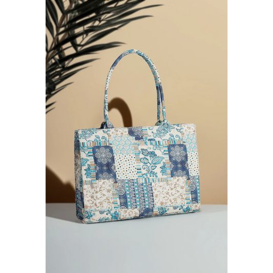 Bagwati blue patchwork canvas handbag with floral and geometric patterns, tabletop display