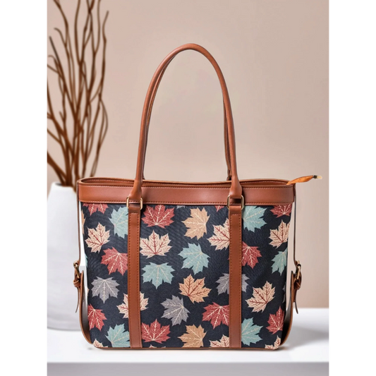 Bagwati autumn leaf canvas tote bag with brown straps, multicolor print, on tabletop