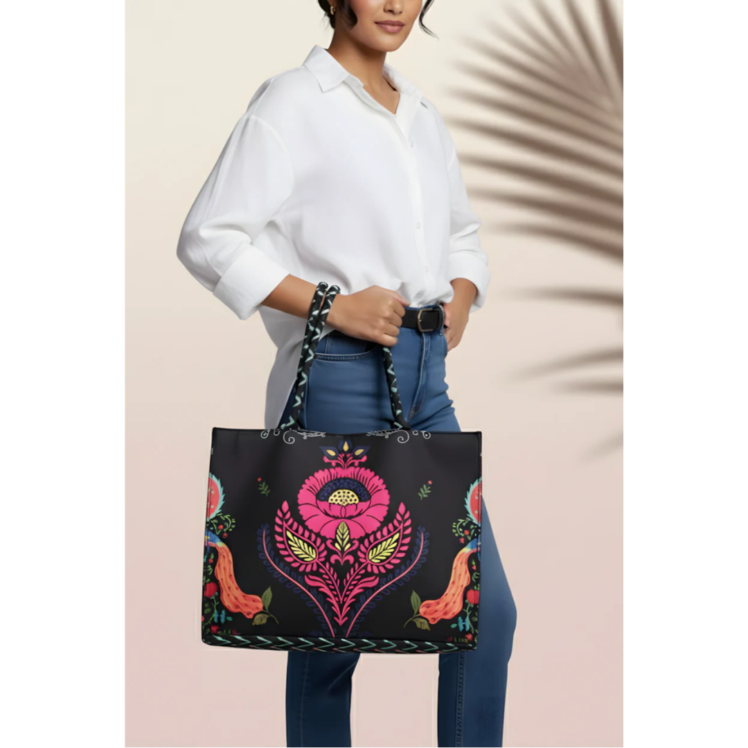 Woman holding Bagwati Carnival Canvas Tote Black with vibrant floral embroidery, stylish design.