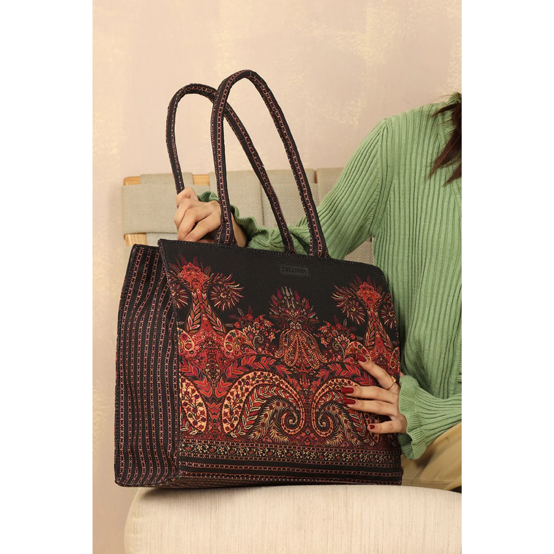 Bagwati Mughal Muse red patterned canvas tote bag with double handles, held by a woman