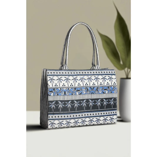 Bagwati palm tree canvas tote bag in blue and white with striped design, displayed on table