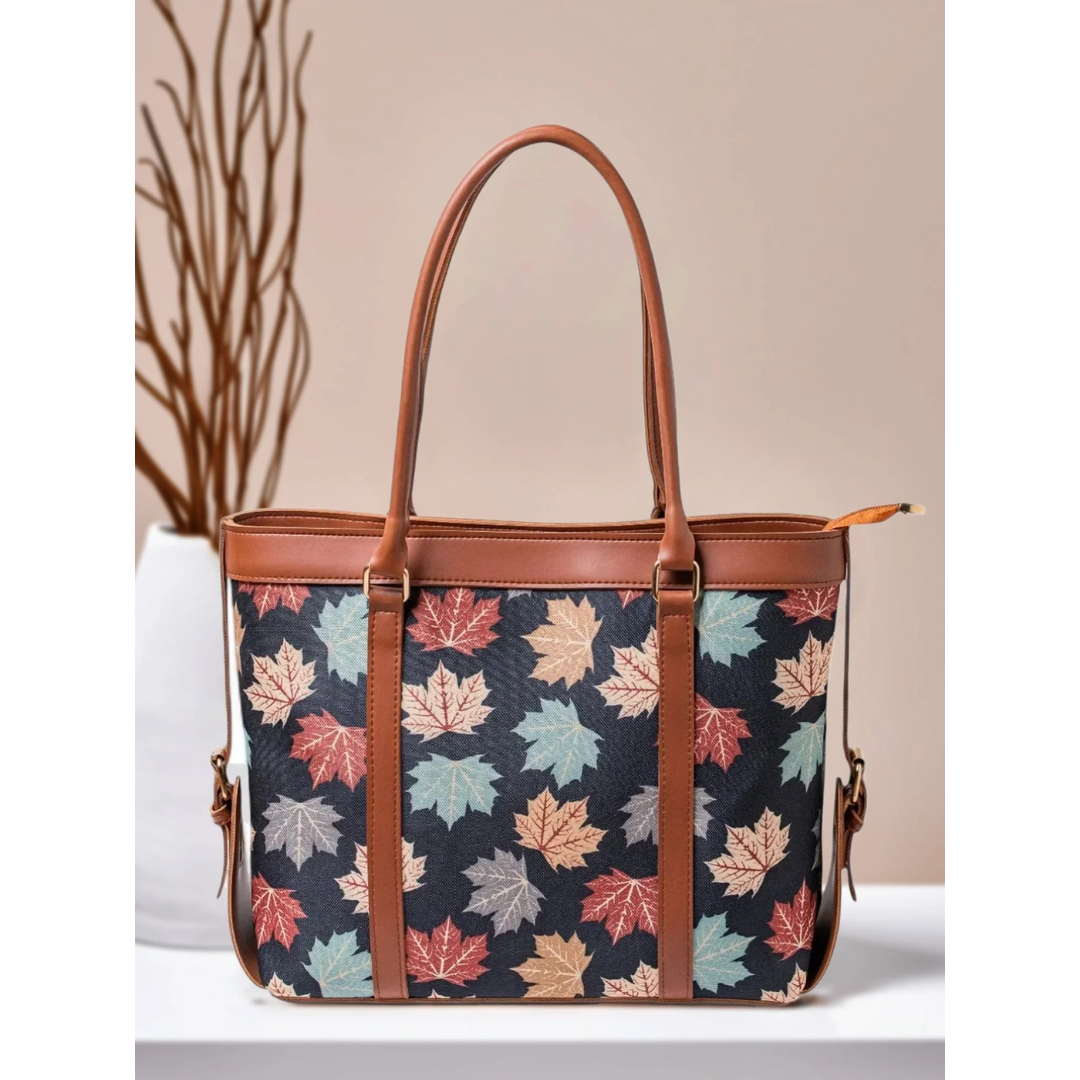 Bagwati autumn leaf canvas tote bag with brown straps, multicolor print, on tabletop
