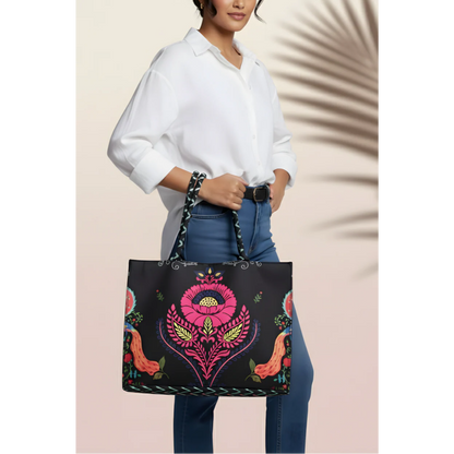 Woman holding Bagwati Carnival Canvas Tote Black with vibrant floral embroidery, stylish design.