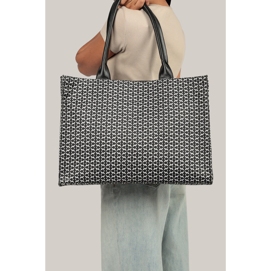 Bagwati monochrome canvas tote bag in black with geometric pattern, held by a model