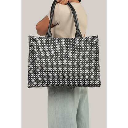 Bagwati monochrome canvas tote bag in black with geometric pattern, held by a model