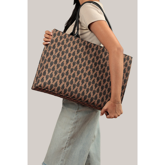 Bagwati brown monochrome canvas tote bag with black pattern, carried on shoulder