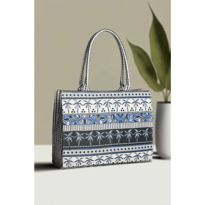 Bagwati palm tree canvas tote bag in blue and white with striped design, displayed on table