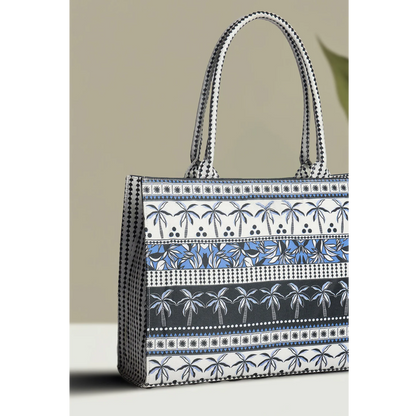 Bagwati canvas tote bag with blue palm tree pattern and dual handles on neutral background