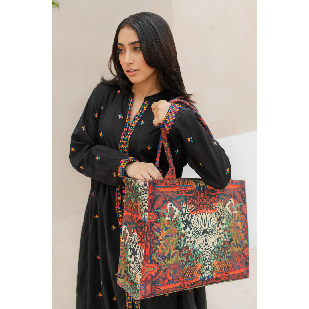 Woman holding Bagwati red tiger art canvas tote bag, vibrant floral design, outdoor setting
