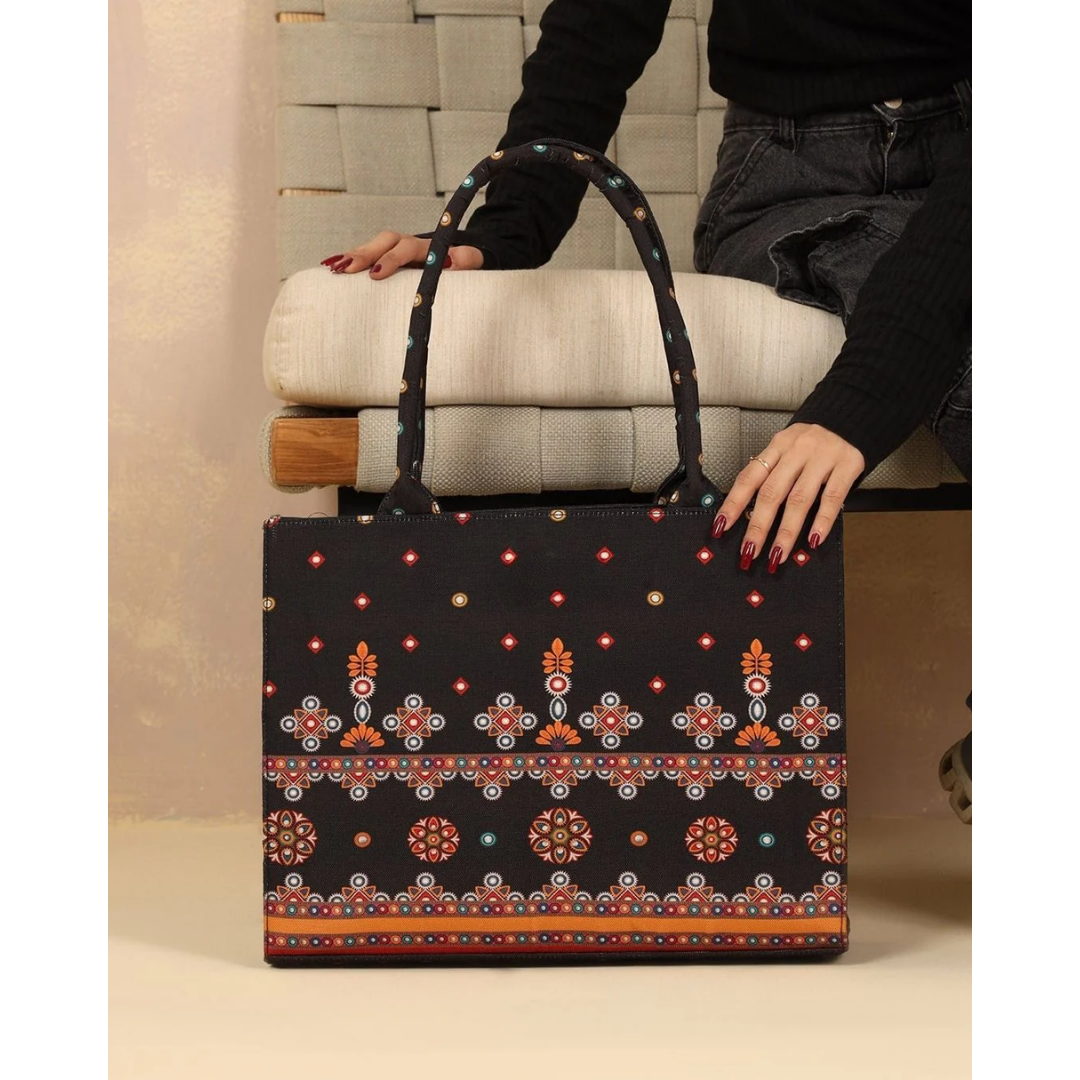 Bagwati traditional black canvas tote bag with vibrant ethnic embroidery, held by model