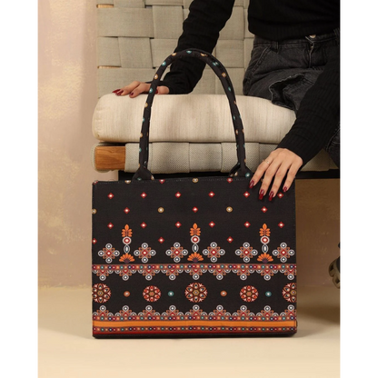 Bagwati traditional black canvas tote bag with vibrant ethnic embroidery, held by model
