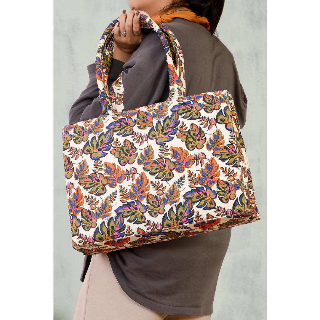 Bagwati tropical canvas tote bag with colorful leaf pattern, held by a woman